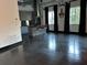 This living room includes access to a kitchen with island and barstool seating, dark wood floors, and lighting at 206 11Th Ne St # 205, Atlanta, GA 30309