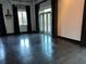 Spacious living room with dark wood floors, chandelier lighting, and access to outdoor balcony at 206 11Th Ne St # 205, Atlanta, GA 30309