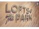 Close-up of the 'Lofts @ The Park' signage on a modern, wood-look lobby wall at 206 11Th Ne St # 205, Atlanta, GA 30309