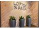 Elegant lobby area with wood-look walls, decorative plants, and 'Lofts @ the Park' sign at 206 11Th Ne St # 205, Atlanta, GA 30309