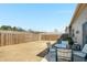 Spacious fenced in backyard with mature landscaping and a lovely patio set for enjoying the outdoors at 2910 Bishopstone Way, Cumming, GA 30040