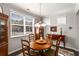 Cozy dining room with a wooden table, chandelier, and a large window providing ample natural light at 2910 Bishopstone Way, Cumming, GA 30040