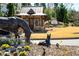 Community entrance with a small building, horse statues, and attractive landscaping at 2910 Bishopstone Way, Cumming, GA 30040