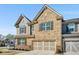Charming two-story home featuring a brick and stone facade, complemented by shutters and a two-car garage at 2910 Bishopstone Way, Cumming, GA 30040