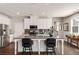 Eat-in kitchen features stainless appliances, granite countertops, and a large island with bar stool seating at 2910 Bishopstone Way, Cumming, GA 30040