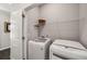 Convenient laundry area with modern, white appliances and practical shelving at 2910 Bishopstone Way, Cumming, GA 30040