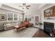 Bright living room features a fireplace, neutral walls, hardwood floors and a door to the patio at 2910 Bishopstone Way, Cumming, GA 30040
