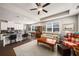 Open-concept living room and kitchen with stainless appliances, granite countertops, and a cozy seating area at 2910 Bishopstone Way, Cumming, GA 30040