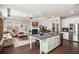 Open concept kitchen and living room features stainless appliances, granite counters, and fireplace at 2910 Bishopstone Way, Cumming, GA 30040