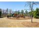 Outdoor playground with slide, swings, climbing area, benches, and perimeter fence at 2910 Bishopstone Way, Cumming, GA 30040
