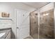 Stylish bathroom showcasing a tiled walk-in shower with glass door at 2910 Bishopstone Way, Cumming, GA 30040