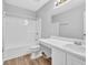 Bathroom including shower-tub combination, toilet, vanity, and wood look flooring at 4571 Parkway Cir, Atlanta, GA 30349