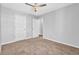 Neutral bedroom with plush carpeting, a ceiling fan and an ensuite bathroom at 4571 Parkway Cir, Atlanta, GA 30349