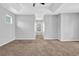 Spacious bedroom with a tray ceiling, neutral carpet and light-grey walls at 4571 Parkway Cir, Atlanta, GA 30349