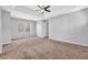 Large bedroom boasts a tray ceiling, plush carpeting, and a ceiling fan at 4571 Parkway Cir, Atlanta, GA 30349