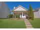 Charming home featuring a well-manicured lawn and inviting front porch at 4571 Parkway Cir, Atlanta, GA 30349