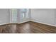 Bright living room features vinyl plank flooring, a glass patio door and large window for natural light at 4571 Parkway Cir, Atlanta, GA 30349