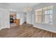 Open-concept living space with wood-look flooring, a modern light fixture, and a view of the kitchen at 4571 Parkway Cir, Atlanta, GA 30349