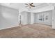 Bright bedroom with tray ceiling, ceiling fan, large window offering natural light, and neutral carpet at 4571 Parkway Cir, Atlanta, GA 30349