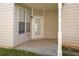 Covered patio area with concrete flooring and a white framed glass door at 4571 Parkway Cir, Atlanta, GA 30349