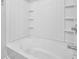 Clean shower-tub combination with white tile surround and built-in shelving at 4571 Parkway Cir, Atlanta, GA 30349