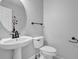 Modern half bathroom with stylish fixtures and a pedestal sink at 617 Creekstone Ct, Jonesboro, GA 30236