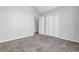 Spacious bedroom with neutral walls and carpet, closet and ample natural light from window at 617 Creekstone Ct, Jonesboro, GA 30236