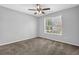 Bedroom with a ceiling fan and a window, complemented by neutral walls and flooring at 617 Creekstone Ct, Jonesboro, GA 30236
