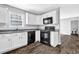 Bright kitchen with white cabinets, granite countertops and stainless steel appliances at 617 Creekstone Ct, Jonesboro, GA 30236