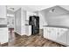 Kitchen featuring white cabinetry, granite countertops, and stainless steel refrigerator at 617 Creekstone Ct, Jonesboro, GA 30236