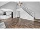 Bright living room features vaulted ceiling, fireplace, hardwood floors, and kitchen access at 617 Creekstone Ct, Jonesboro, GA 30236