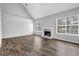 Open-concept living room with a fireplace, hardwood floors, and neutral wall color at 617 Creekstone Ct, Jonesboro, GA 30236