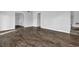 Living room with neutral walls and wood-look floors plus a carpeted staircase at 617 Creekstone Ct, Jonesboro, GA 30236