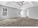 Main bedroom featuring tray ceilings, natural light and neutral walls at 617 Creekstone Ct, Jonesboro, GA 30236