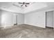 Spacious main bedroom with large windows and neutral carpet flooring at 617 Creekstone Ct, Jonesboro, GA 30236