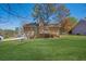 Expansive backyard featuring a well-maintained lawn, a deck, and mature trees surrounding the property at 8633 Hilltop Rd, Jonesboro, GA 30236