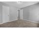 A bedroom showing gray walls, neutral color carpet, and two entry doors at 8633 Hilltop Rd, Jonesboro, GA 30236