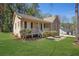 Cozy home with a welcoming front porch, lush lawn, and mixed siding at 8633 Hilltop Rd, Jonesboro, GA 30236