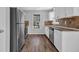 Well-lit kitchen featuring stainless appliances and hardwood flooring at 8633 Hilltop Rd, Jonesboro, GA 30236