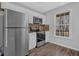 Bright kitchen with stainless steel appliances and a window overlooking the yard at 8633 Hilltop Rd, Jonesboro, GA 30236