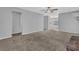 Spacious living room with a warm-toned carpet and bright neutral wall paint at 8633 Hilltop Rd, Jonesboro, GA 30236