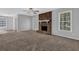 Bright living room with a brick fireplace, soft carpet, and plenty of natural light at 8633 Hilltop Rd, Jonesboro, GA 30236