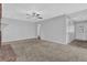 Spacious living room with a warm-toned carpet and bright neutral wall paint at 8633 Hilltop Rd, Jonesboro, GA 30236