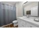 Bathroom featuring a white vanity with a framed mirror and a gray shower curtain over the bathtub at 1929 Finnish Ln, Kennesaw, GA 30152