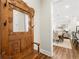 Charming entryway featuring an ornate wooden coat rack and bench, leading to a dining area with modern decor at 1929 Finnish Ln, Kennesaw, GA 30152