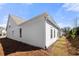 Charming home featuring light gray siding, manicured landscaping, and architectural details on a sunny day at 1929 Finnish Ln, Kennesaw, GA 30152