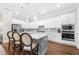 Modern kitchen featuring a central island with seating, stainless steel appliances, and white cabinetry at 1929 Finnish Ln, Kennesaw, GA 30152