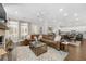 Inviting living room featuring a leather sectional, fireplace, and seamless flow into the dining and kitchen areas at 1929 Finnish Ln, Kennesaw, GA 30152