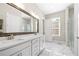 Bright bathroom features white marble floors, double vanity sinks, and a glass-enclosed shower at 1929 Finnish Ln, Kennesaw, GA 30152
