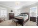 The main bedroom features a king bed, neutral carpet, and classic, dark-wood furnishings at 1929 Finnish Ln, Kennesaw, GA 30152